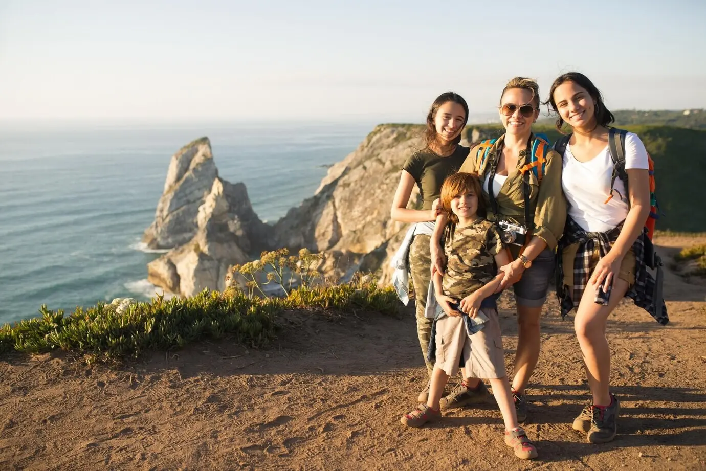 A portrait of a happy mother hiking with her children.