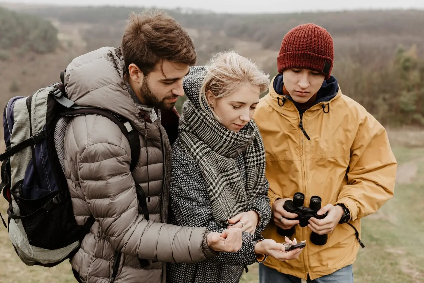 Traveling friends looking at a compass