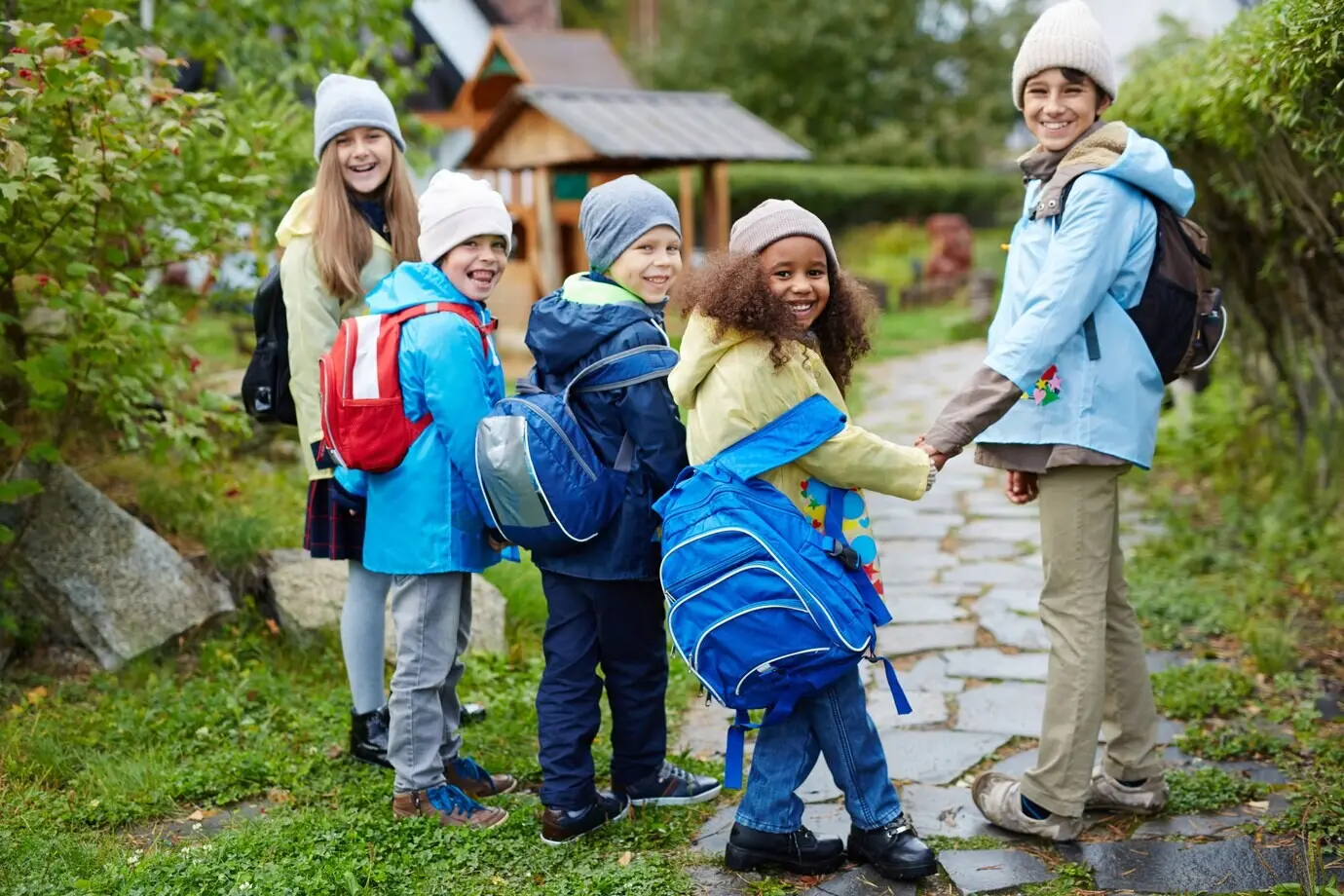 A cheerful group of children walking to school in autumn.